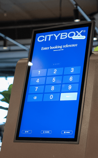 Close-up of Citybox self check-in kiosk with Beetronics touchscreen and card reader.