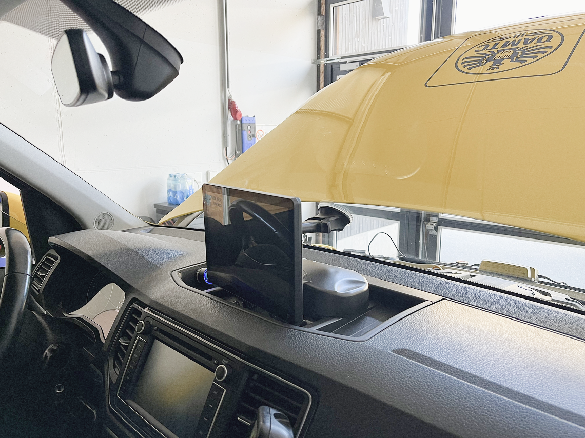 In-vehicle display mounted on a car dashboard, showing an aftermarket automotive screen installed inside a commercial vehicle.